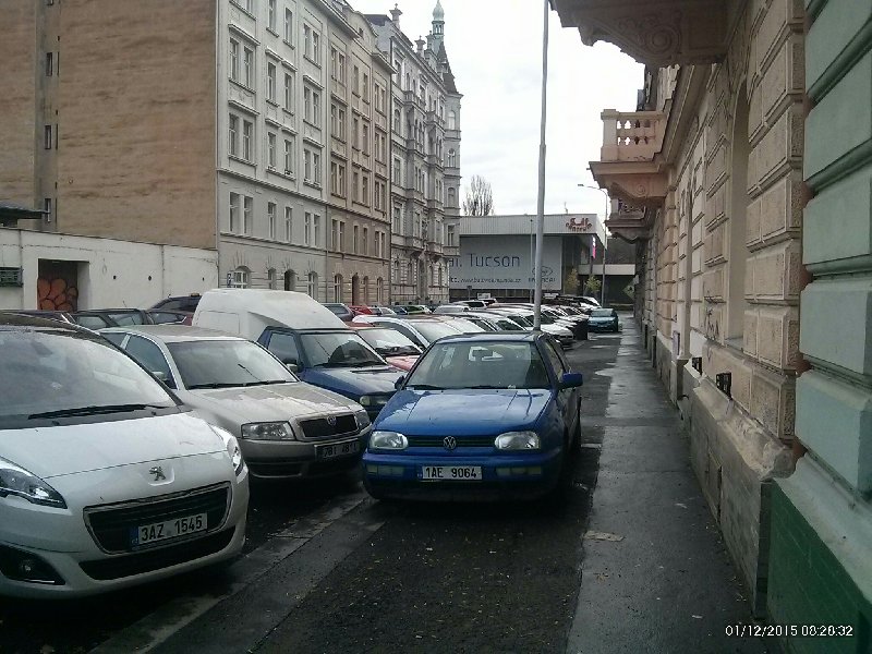 Auta na chodníku v ulici Kotevní